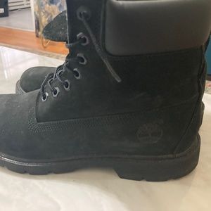 A pair black on black Timberland Boots